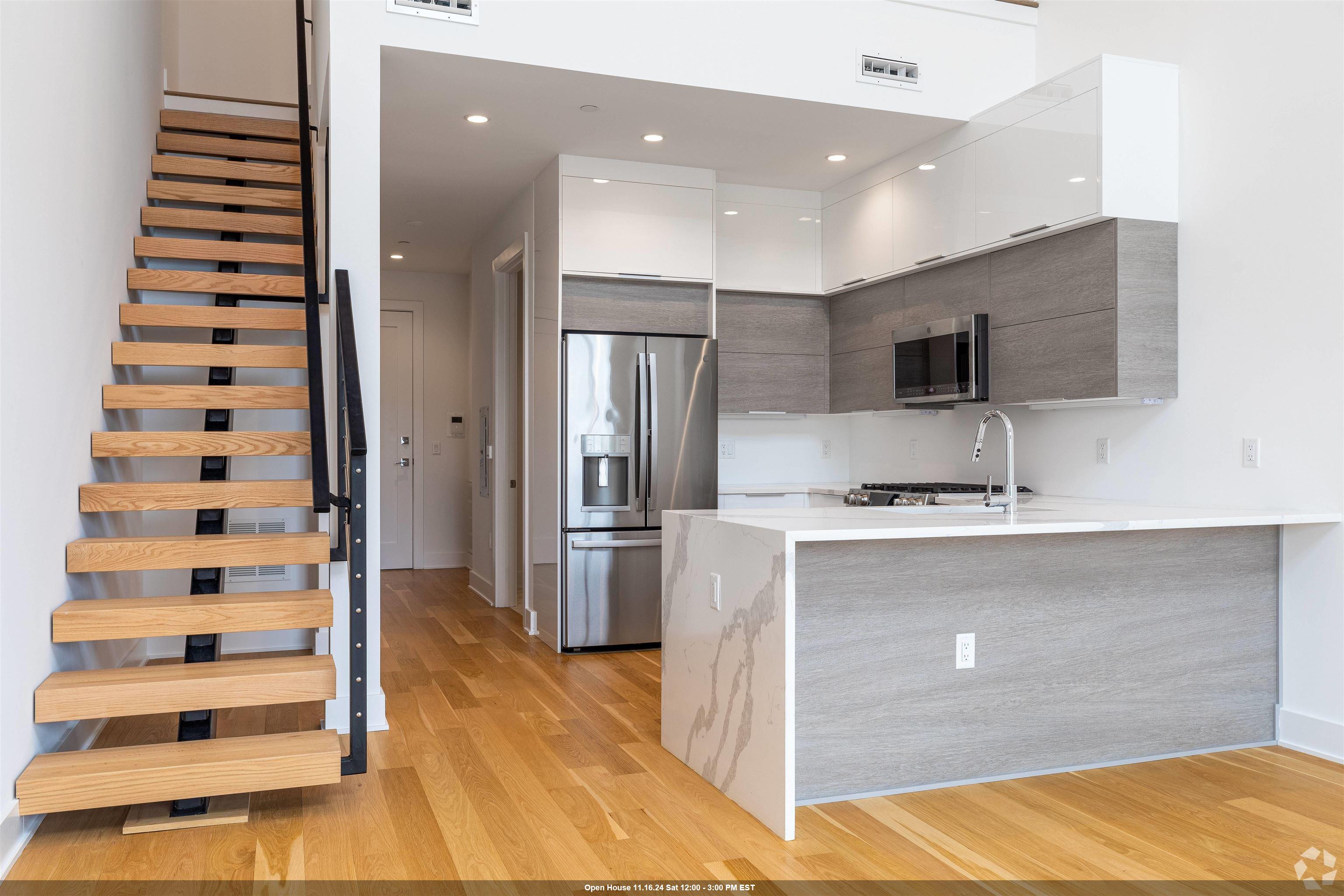 a kitchen with stainless steel appliances a refrigerator and a sink