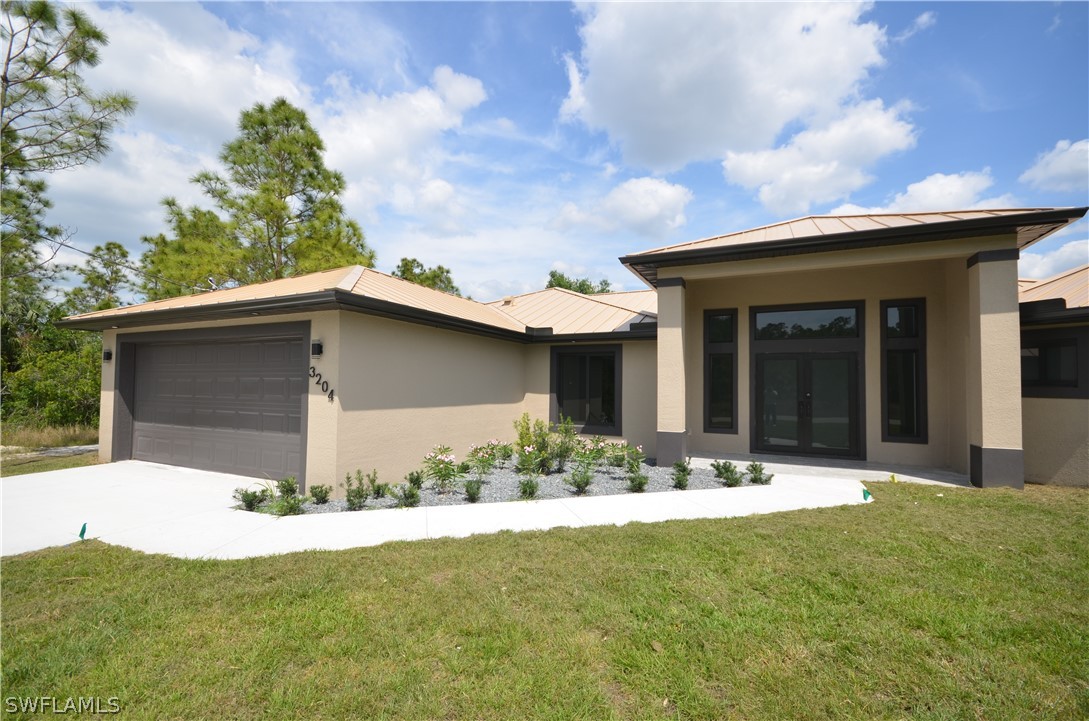 a front view of a house with a yard and garage