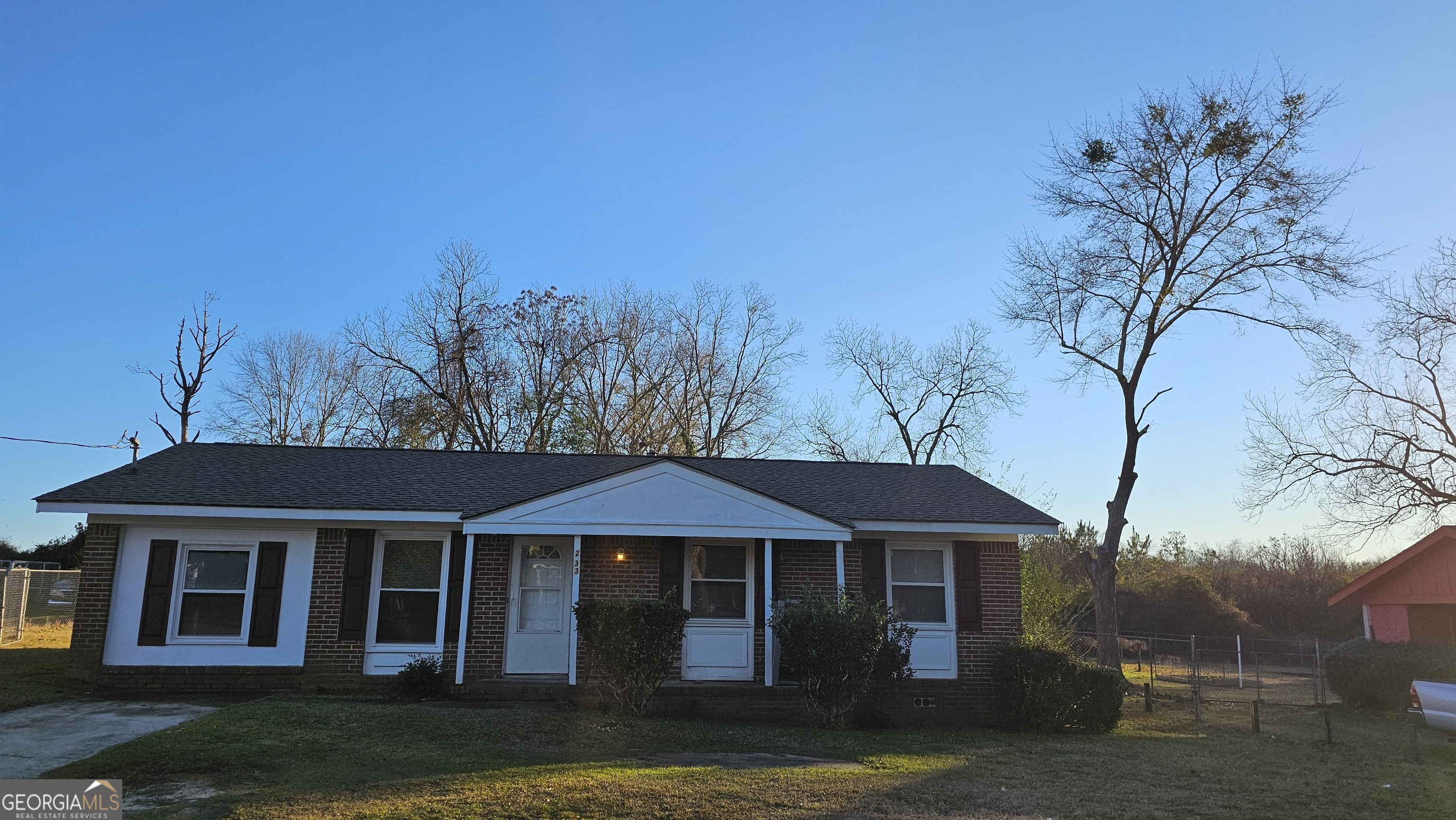 a front view of a house with a garden