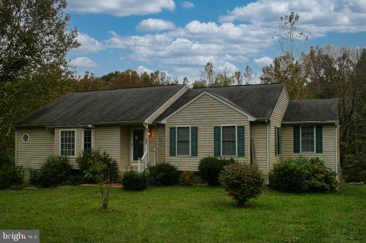 a view of a house with garden and yard