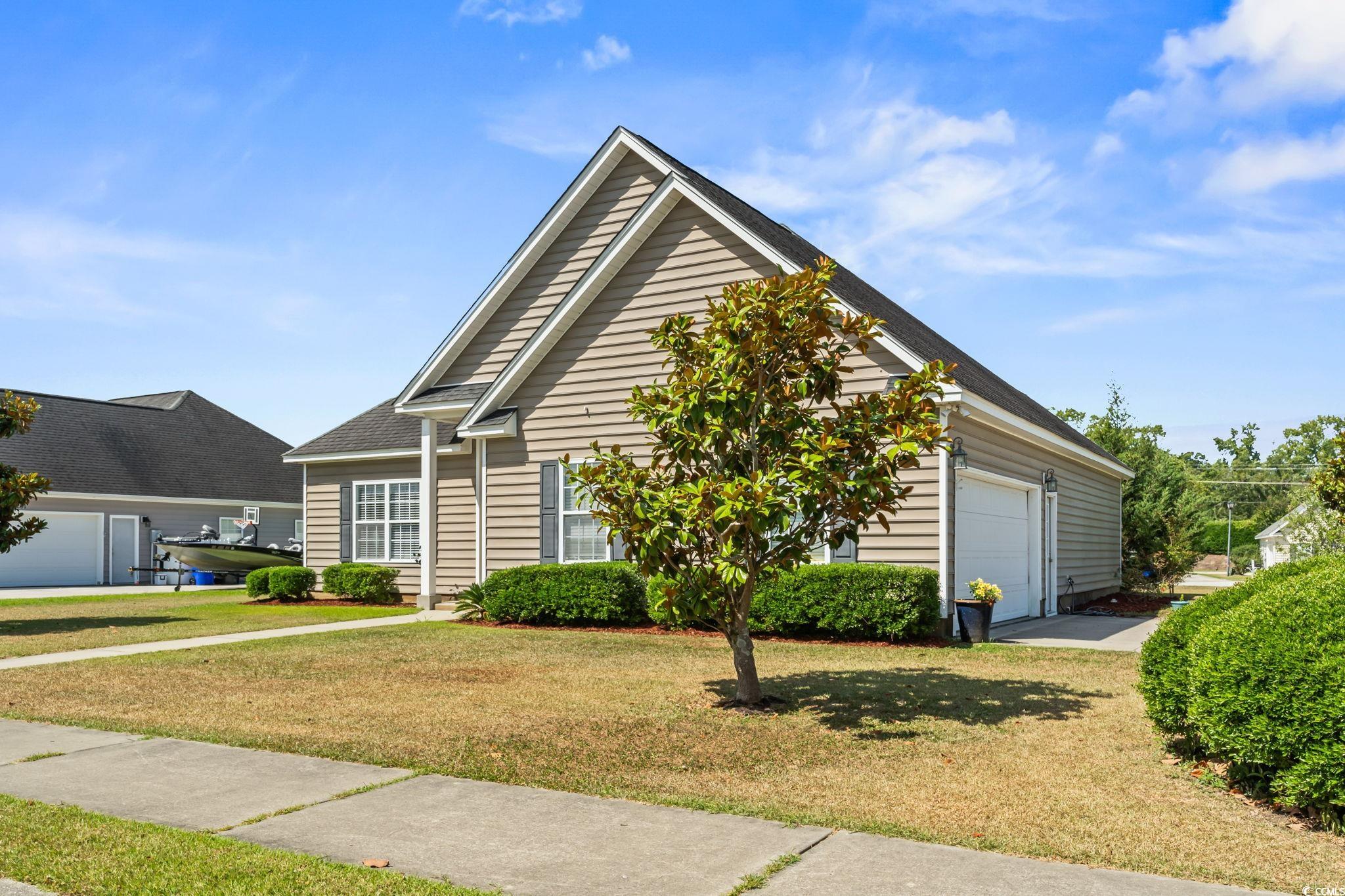 View of front of property featuring a garage and a