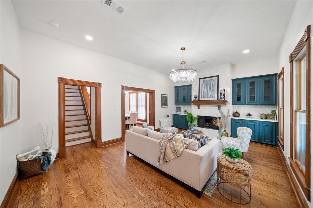 a living room with fireplace furniture and a wooden floor