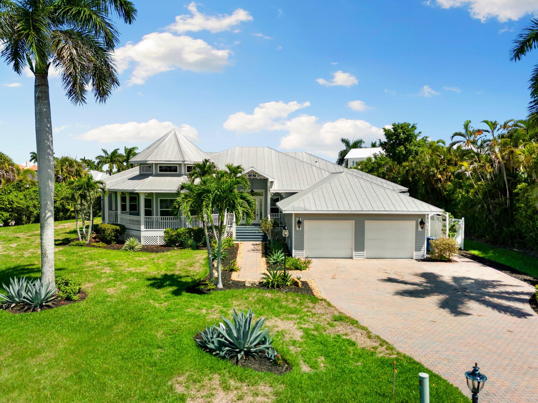 a view of a house with backyard and sitting area