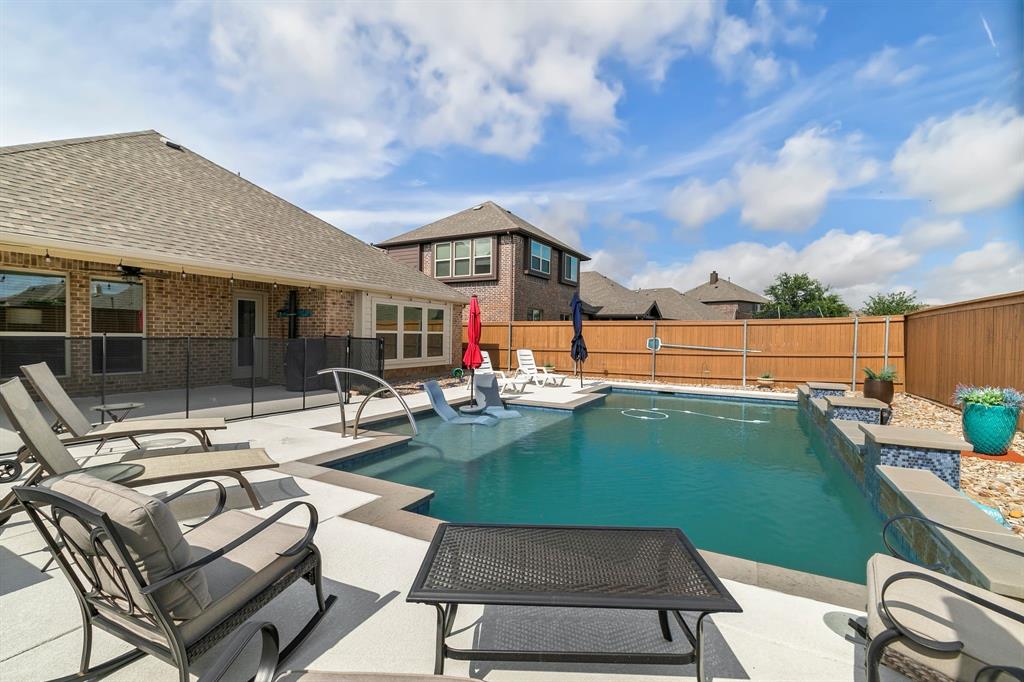 a view of a backyard with sitting area