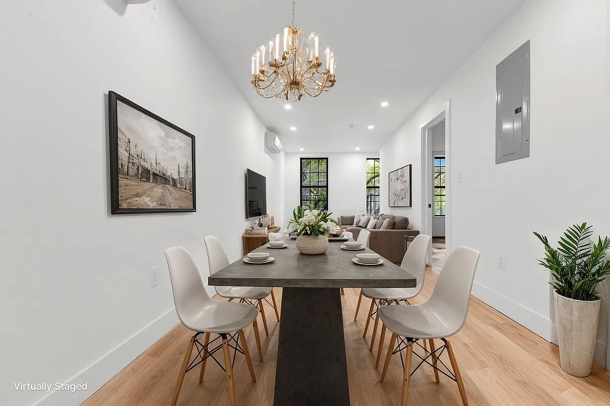 a view of a dining room with furniture and wooden floor