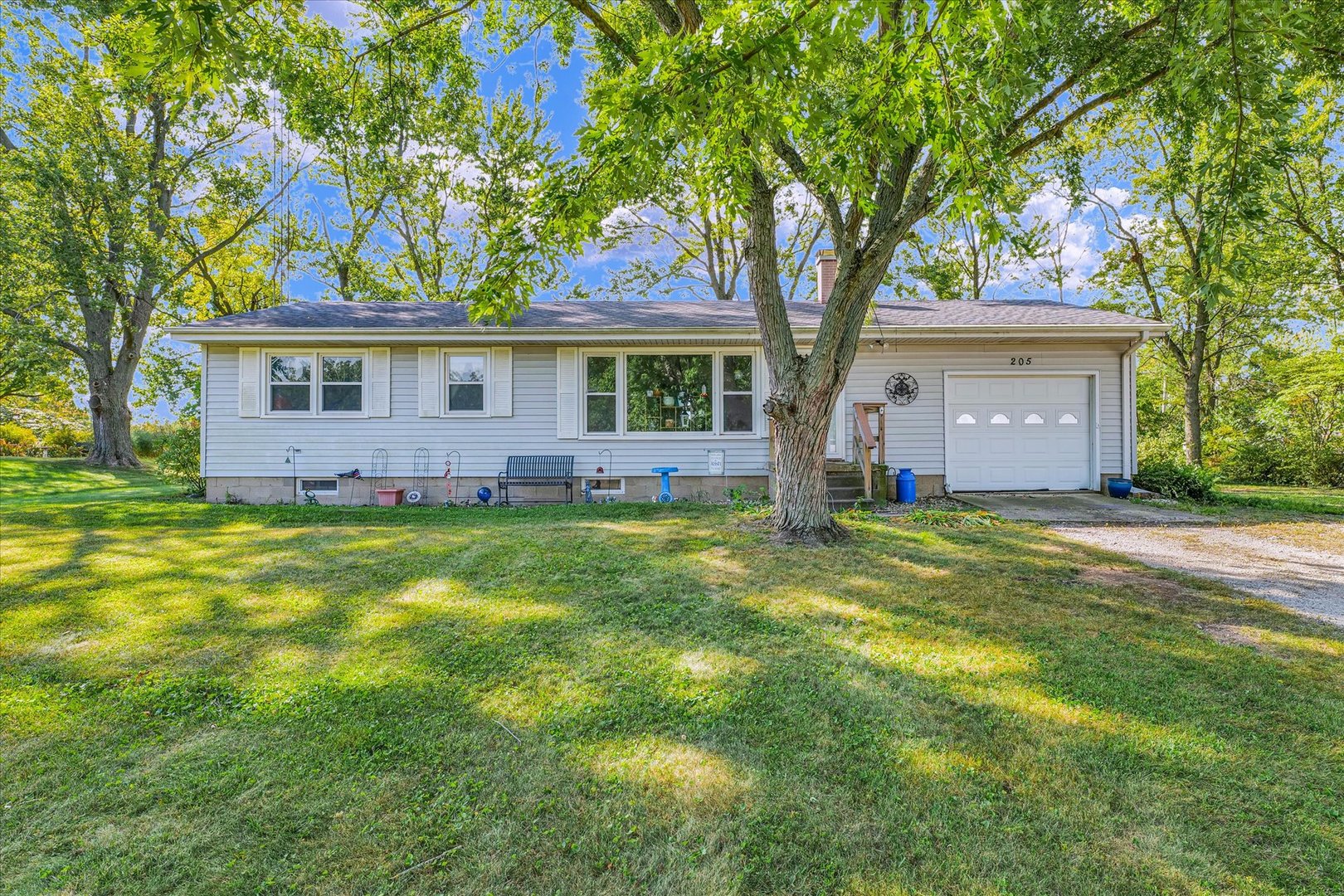 a front view of house with yard and green space