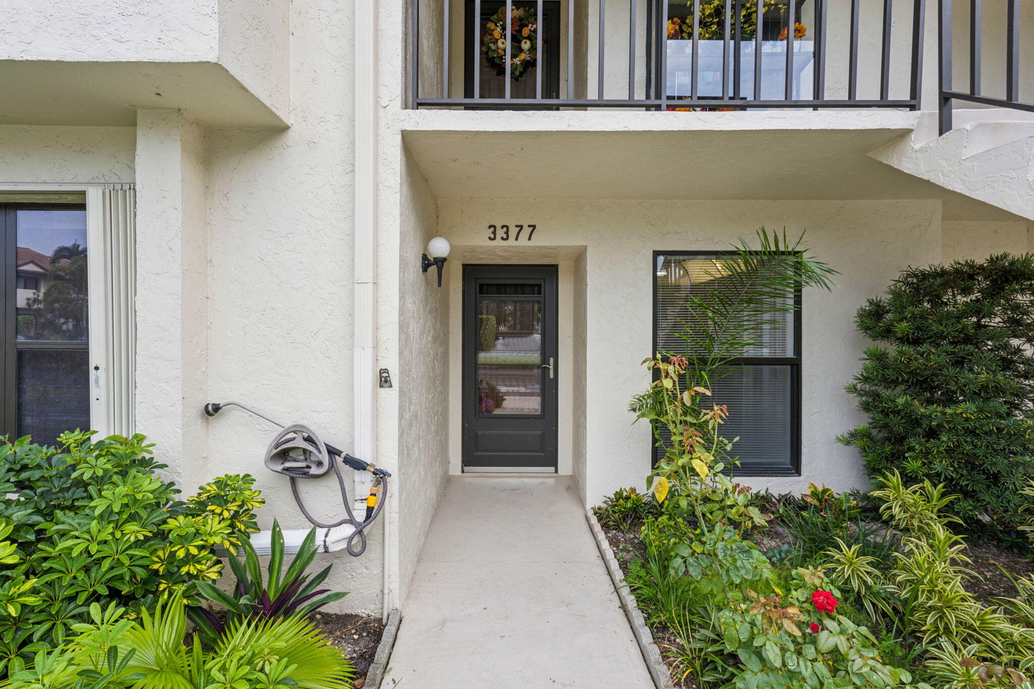 front view of a house with potted plants