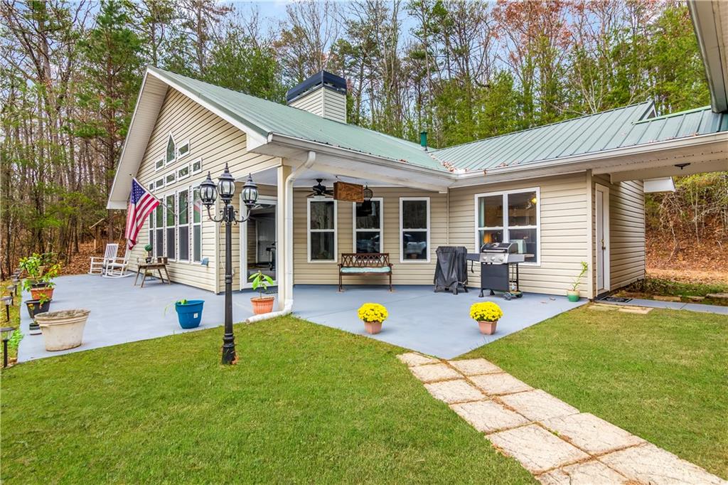 a view of a house with a backyard and a patio