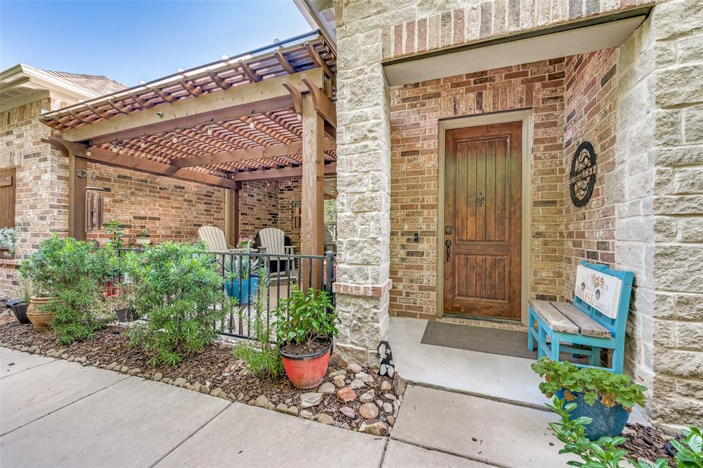 a front view of a house with potted plants