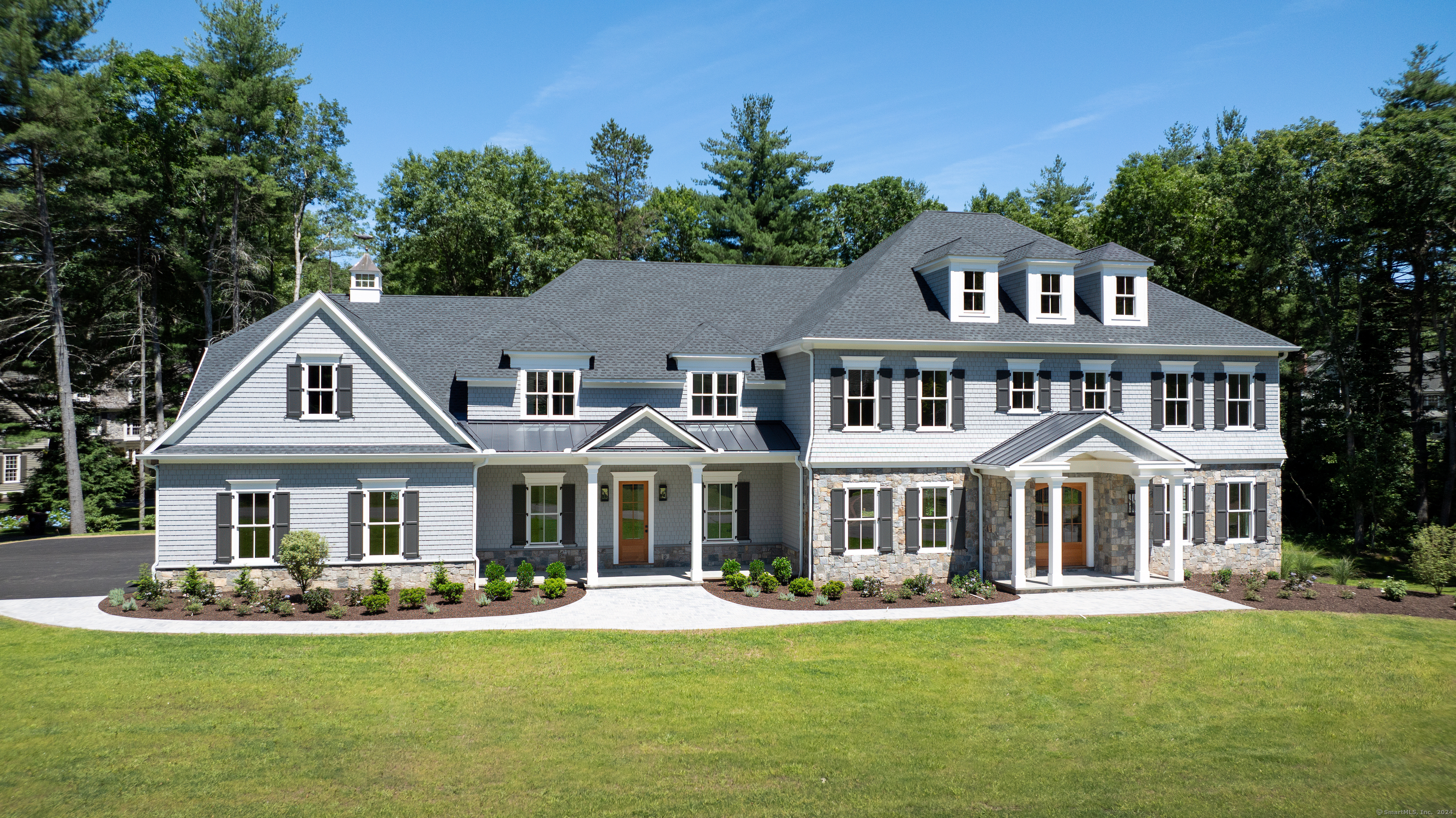 a front view of a residential houses with yard outdoor and green space