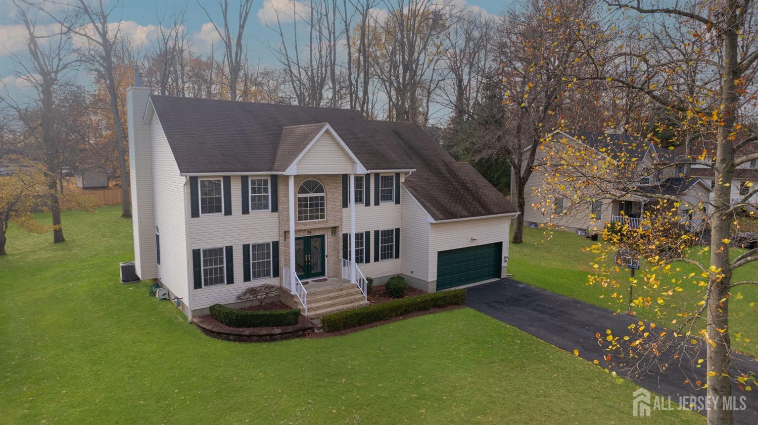 an aerial view of a house with swimming pool and garden