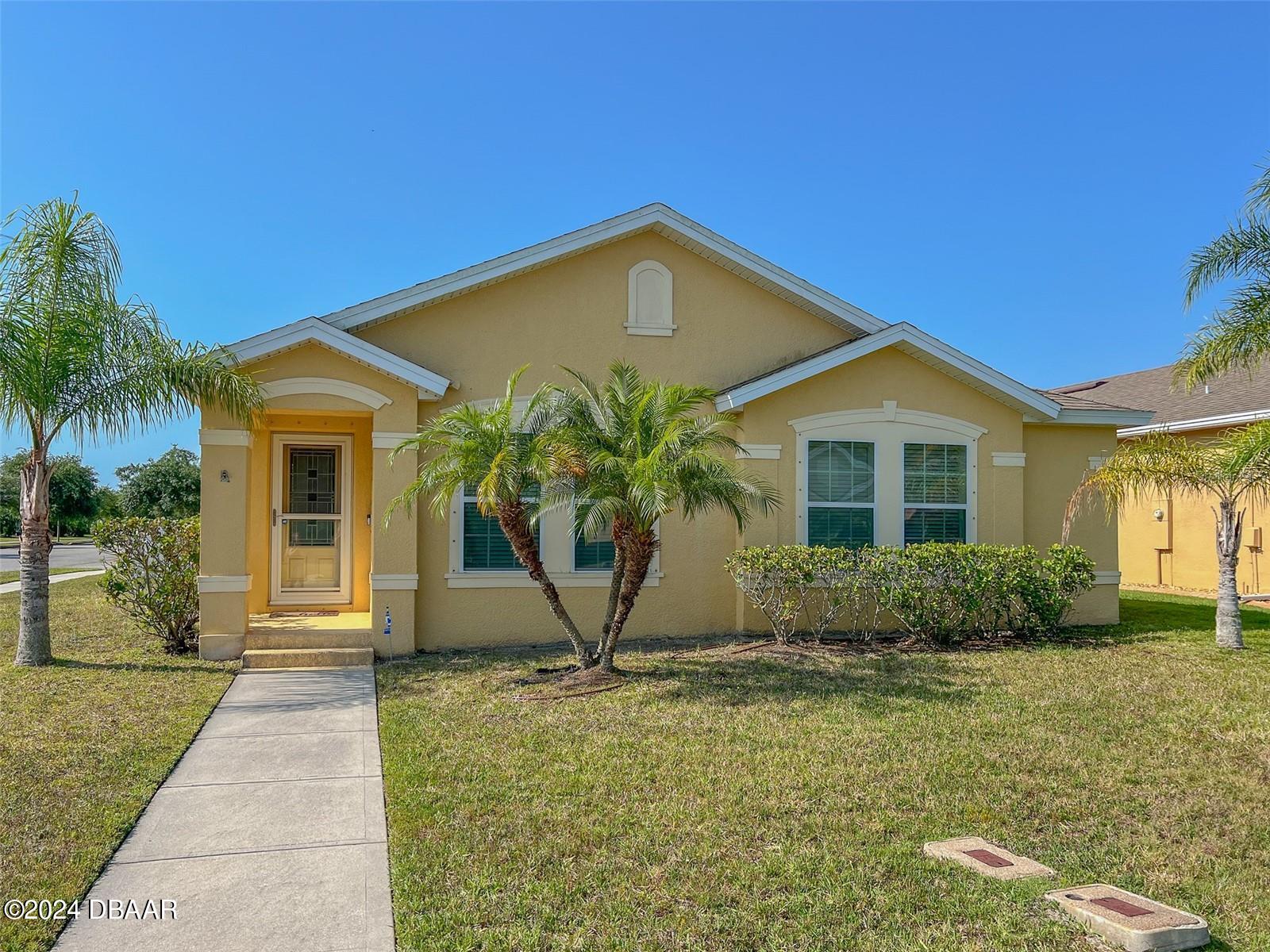 a front view of a house with a yard