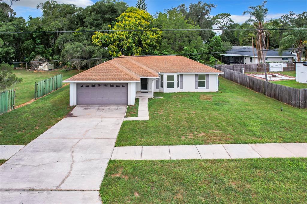 a aerial view of a house with a yard