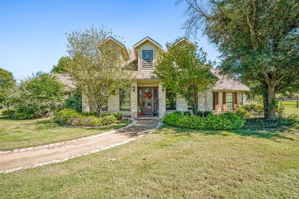 a front view of a house with garden