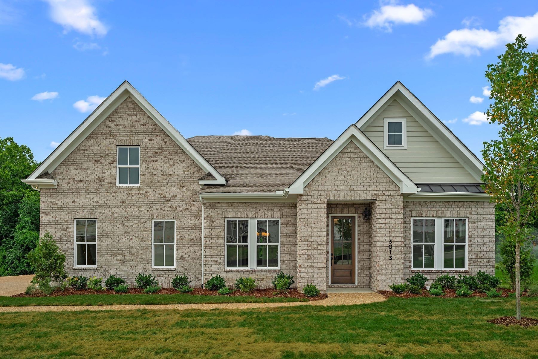 a front view of a house with a yard