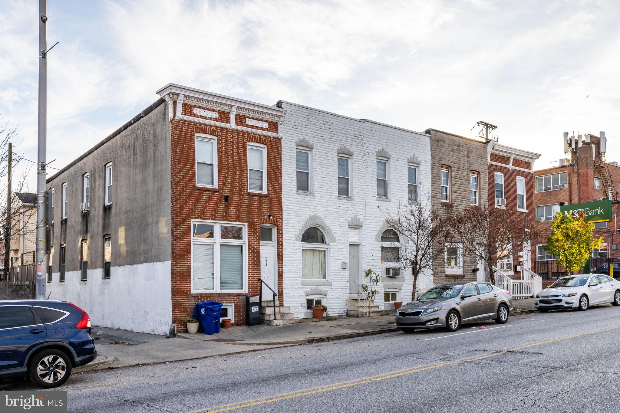 a view of a street that has couple of cars parked on the road