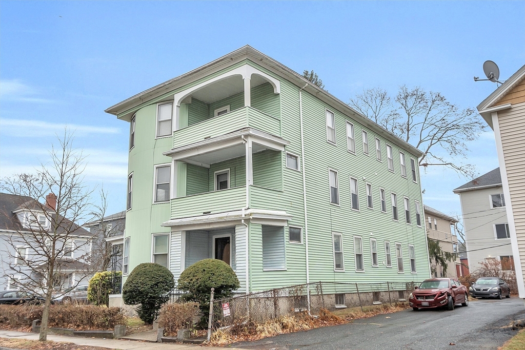 a front view of a residential apartment building with a yard