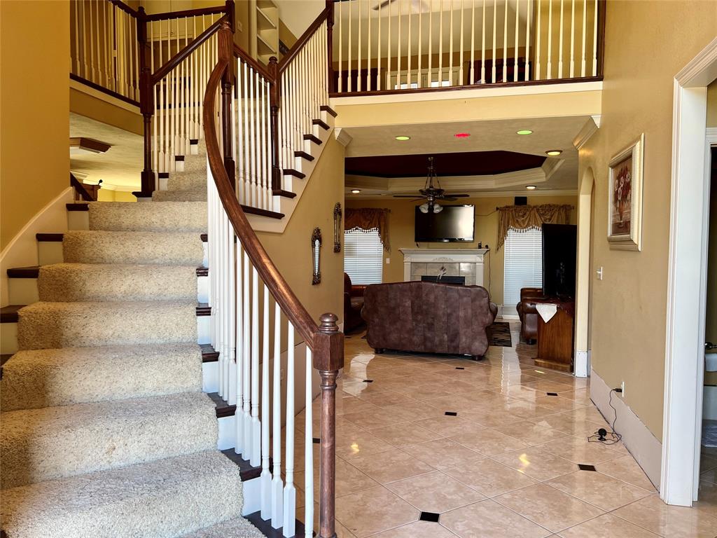 a view of entryway and hall with wooden floor and windows