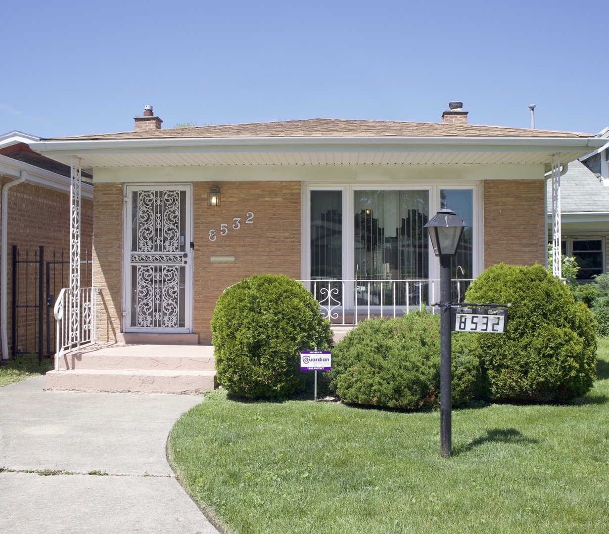 a front view of a house with a garden