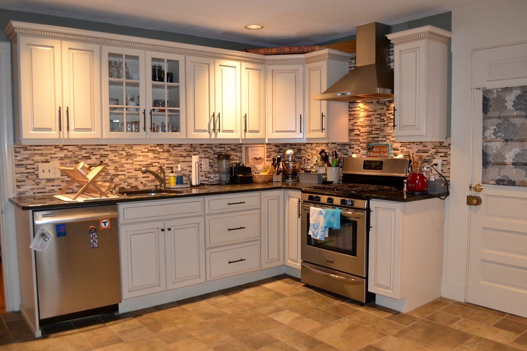 a kitchen with granite countertop a sink and a stove