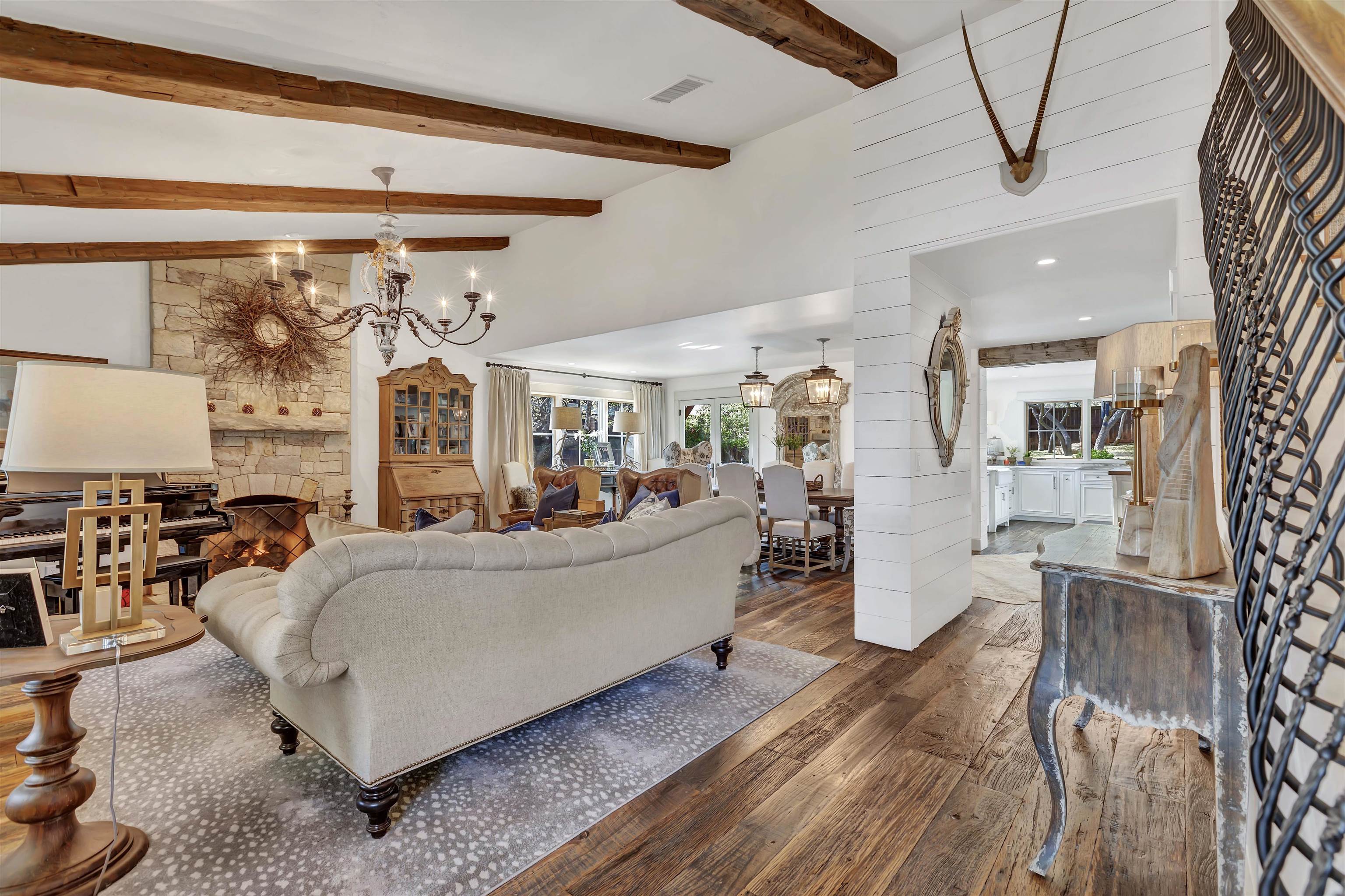 a living room with furniture and a floor to ceiling window