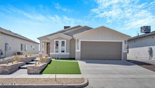 a front view of house with garage and yard