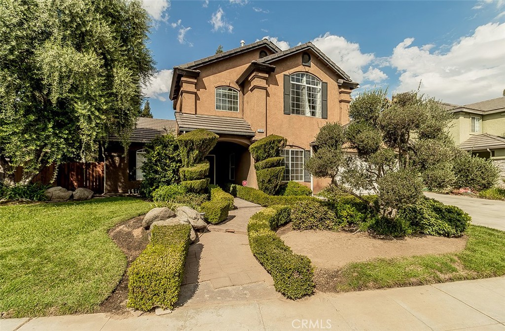 a front view of a house with garden