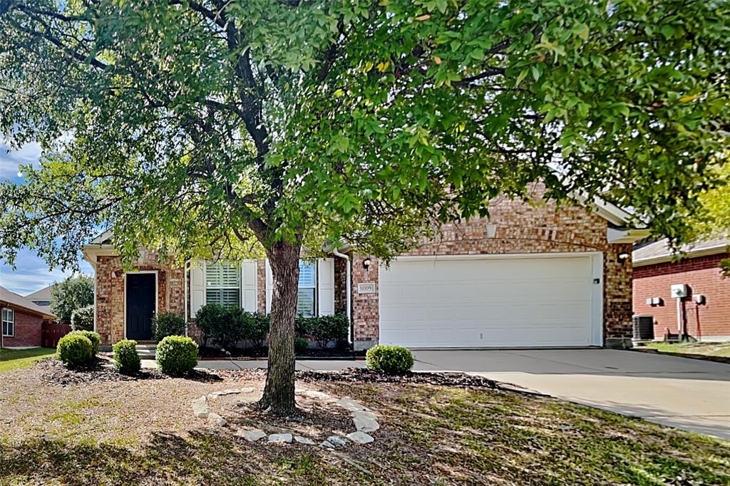 a view of a house with a tree in front