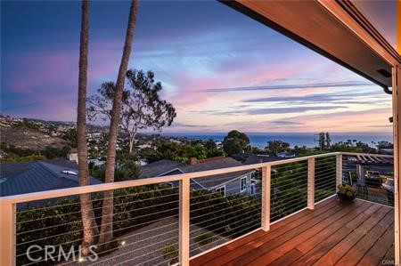 a view of a balcony with wooden floor and city view