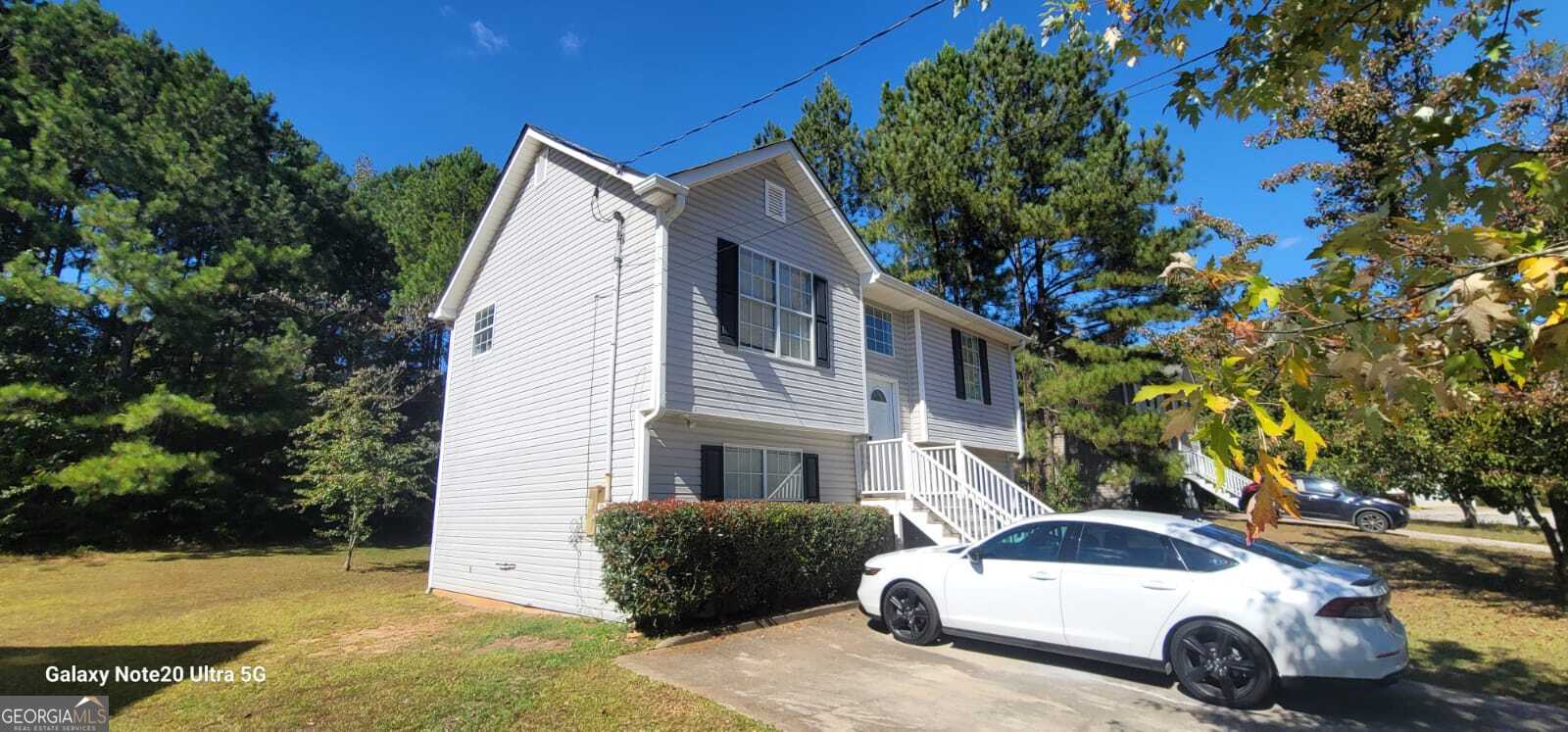 a front view of a house with parking space