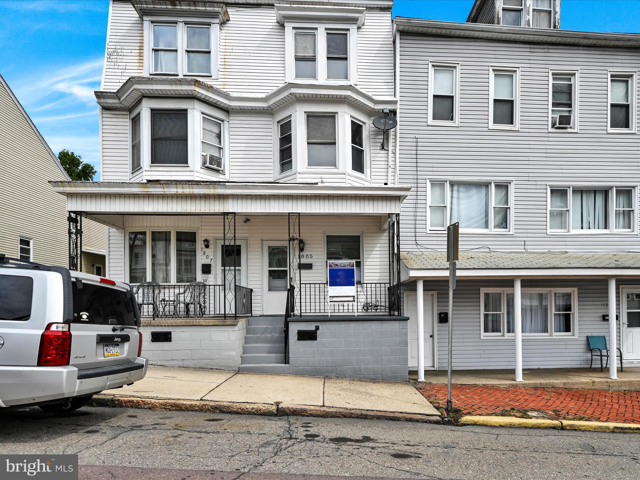 a front view of a residential apartment building with a yard