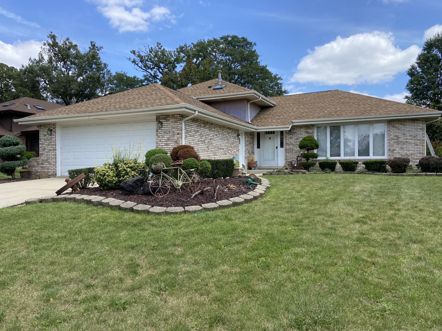 a view of a house with a yard and a garden