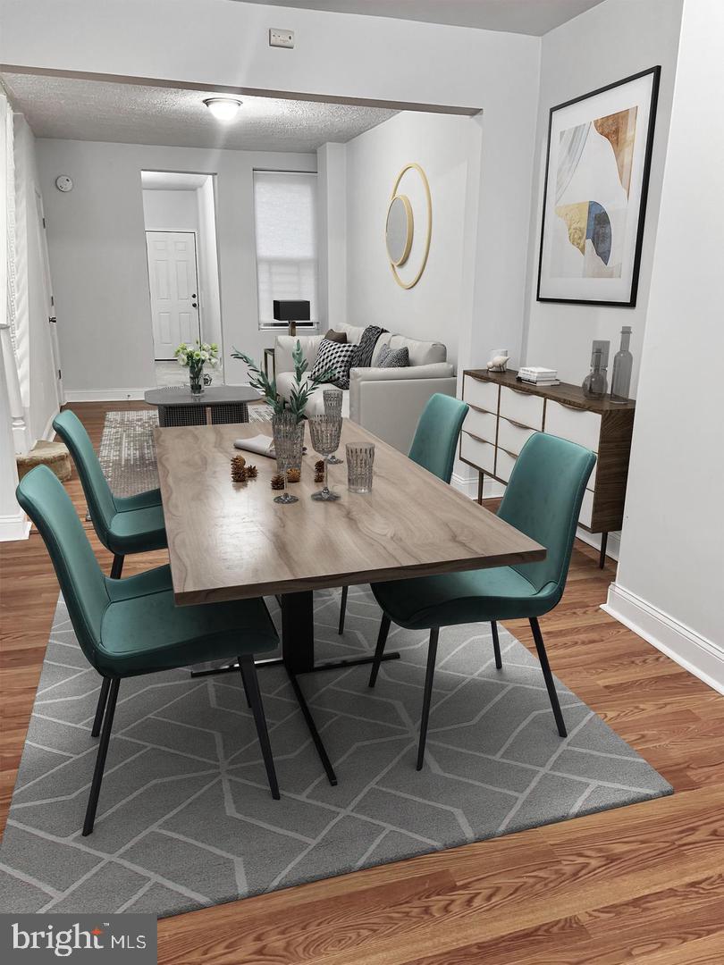 a view of a dining room with furniture and wooden floor