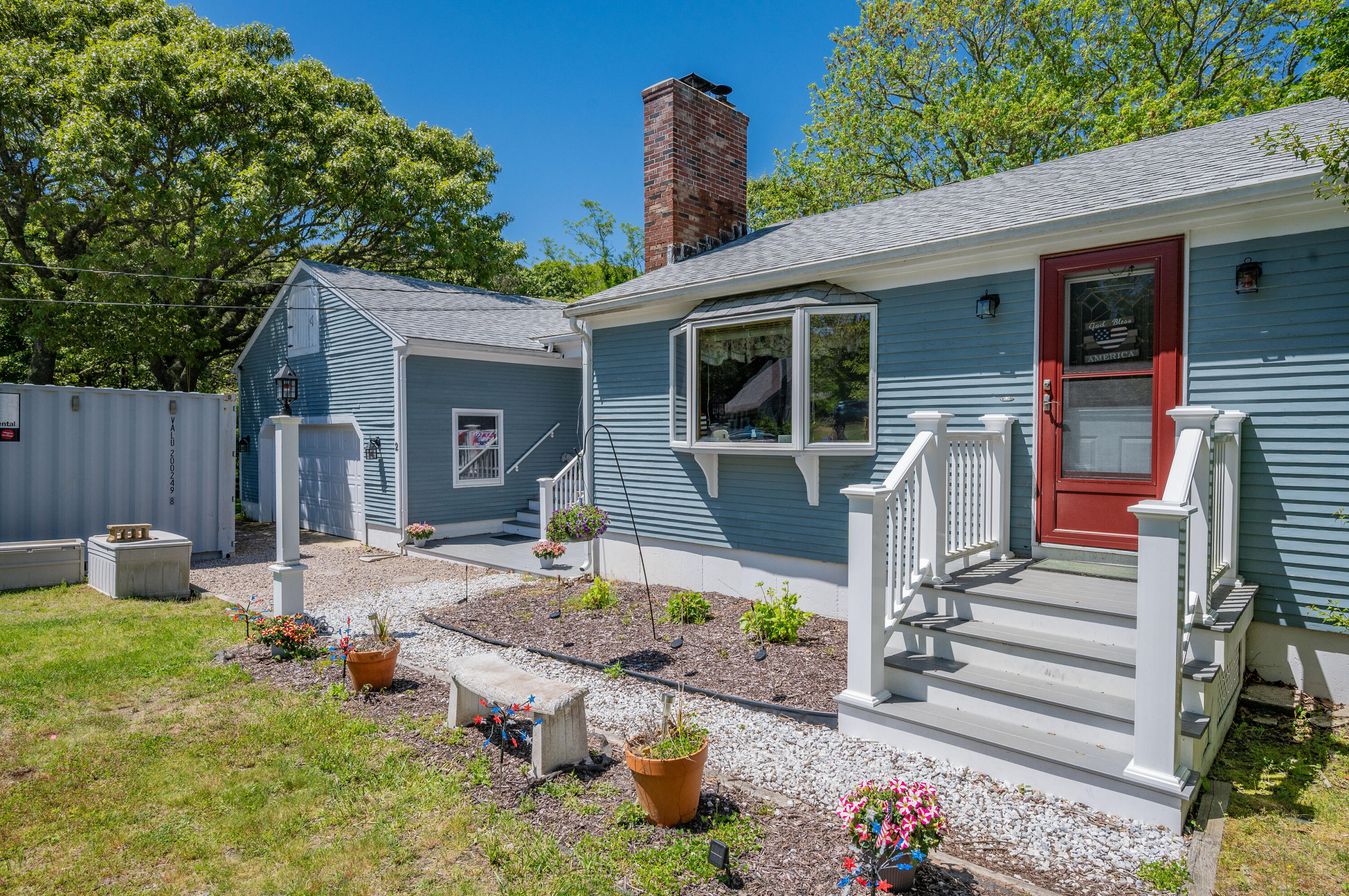 a front view of house with yard outdoor seating and barbeque oven