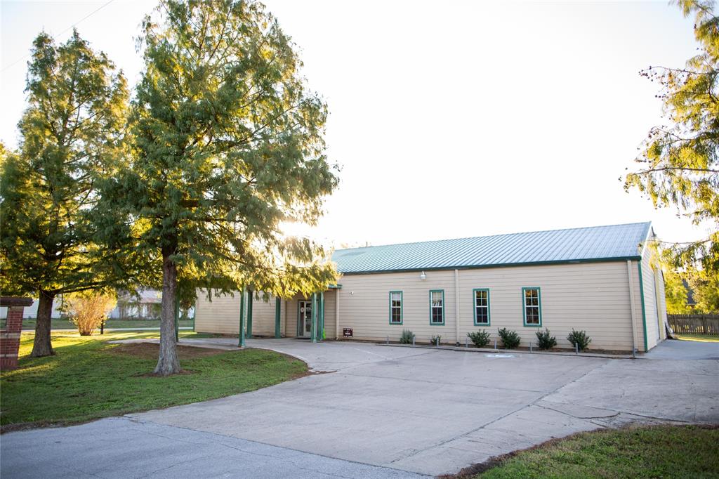 a front view of house with yard and trees