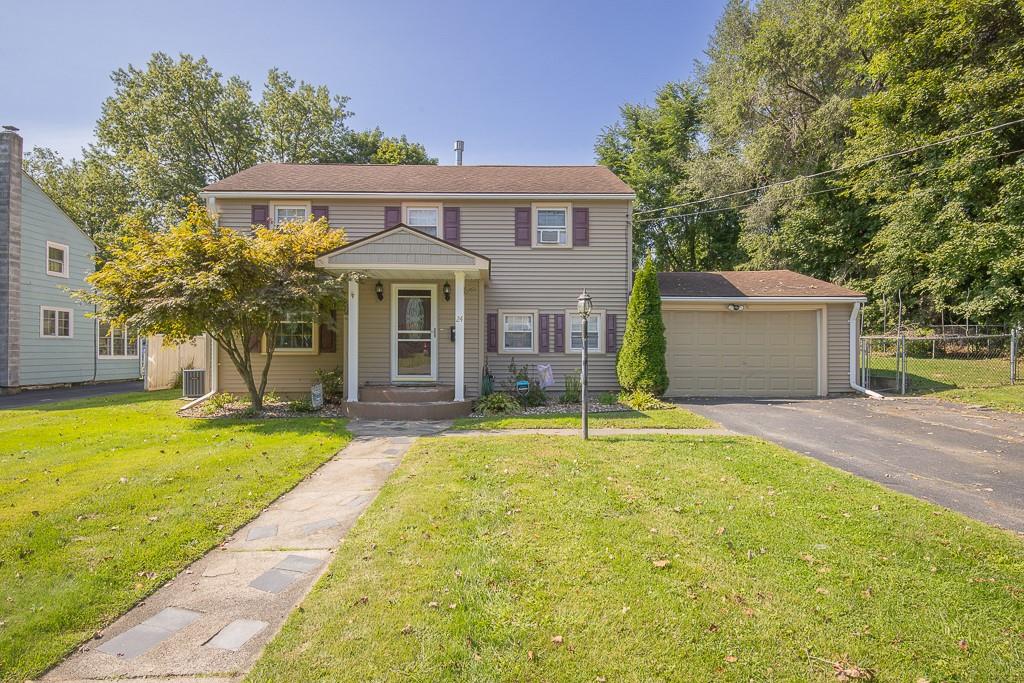 Front view of home with garage and fenced in yard