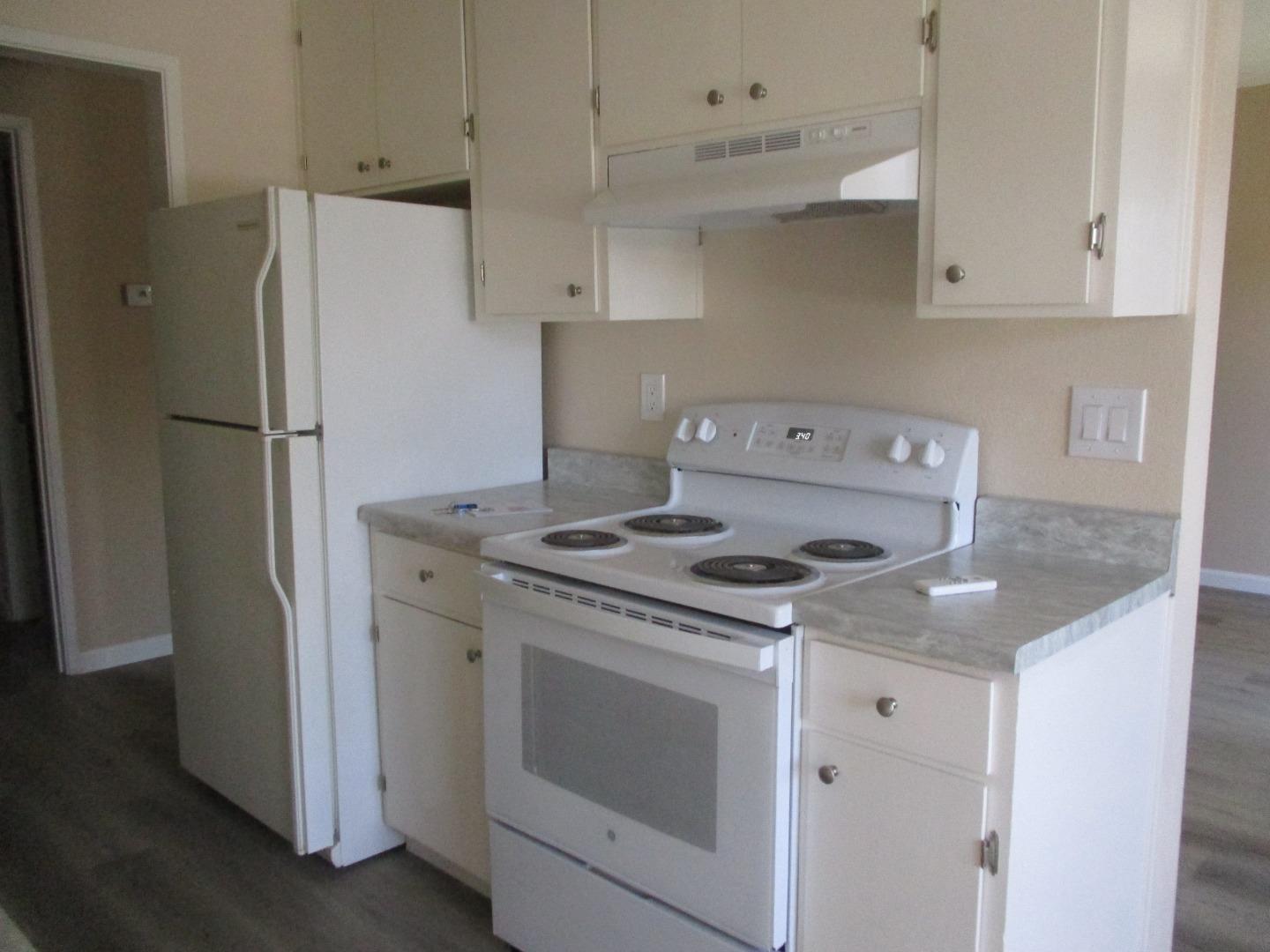 a kitchen with a stove and a refrigerator