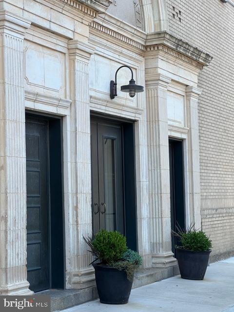 a view of a house with potted plants