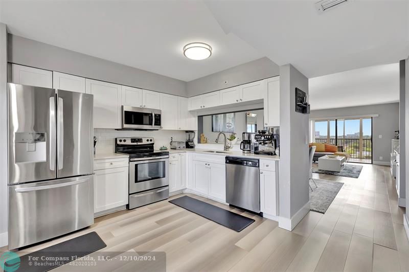 a kitchen with a refrigerator stove and microwave