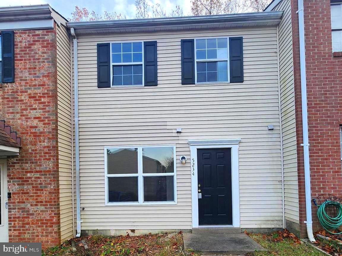 a view of a house with more windows and brick walls