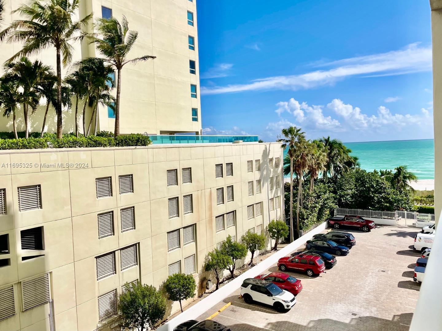 a view of a building with palm trees