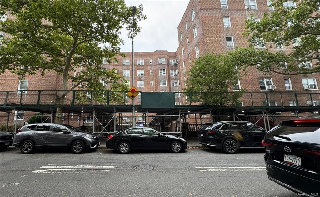 a view of a cars park in front of a building