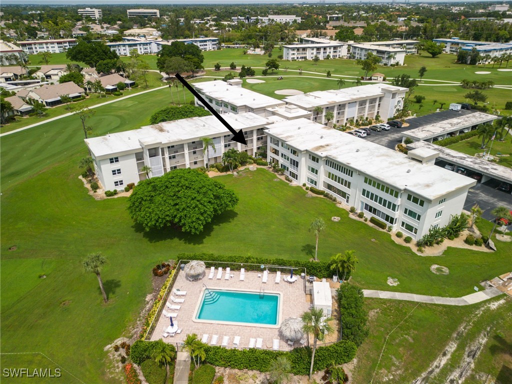 an aerial view of residential houses with outdoor space and river