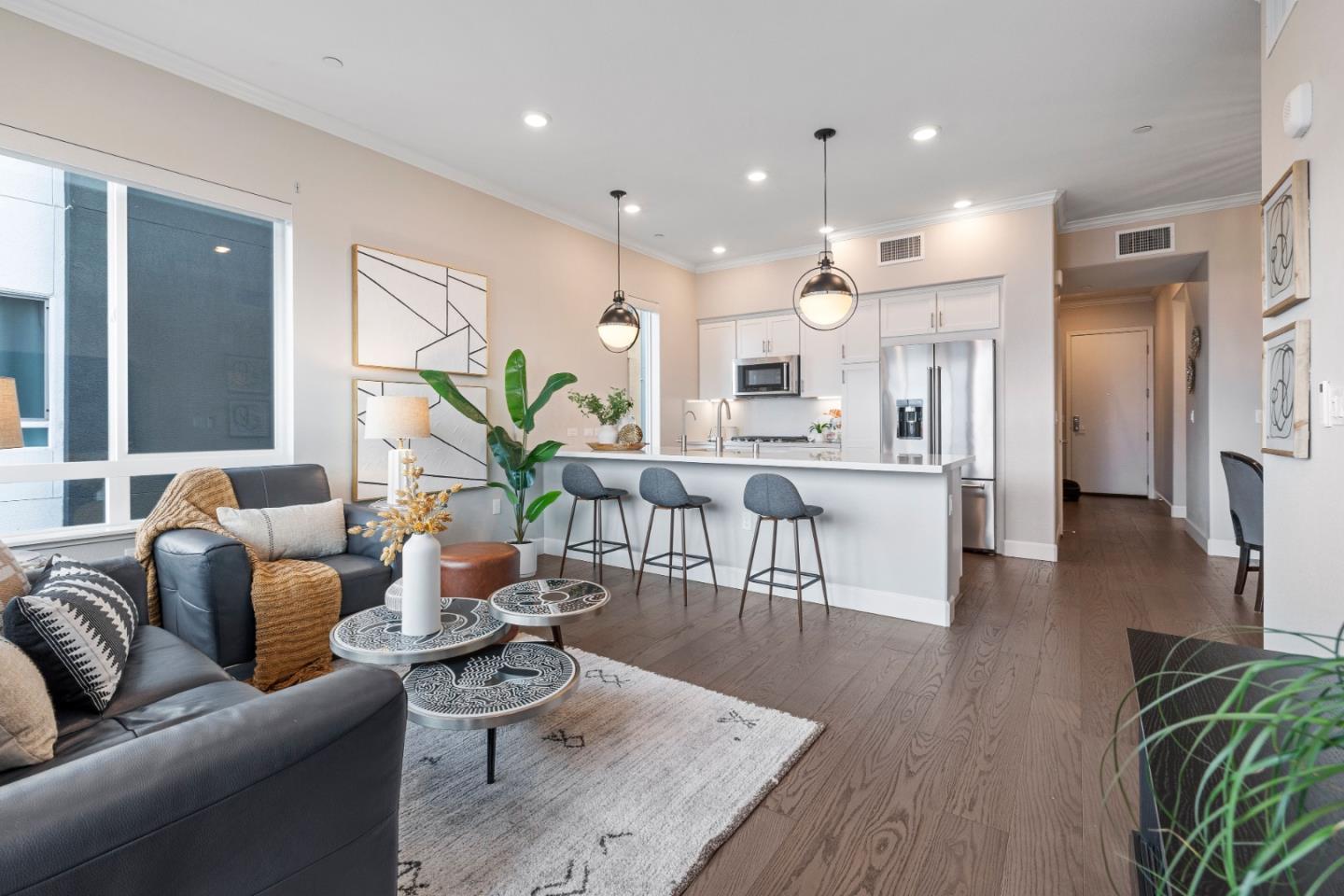 a living room with furniture and a wooden floor