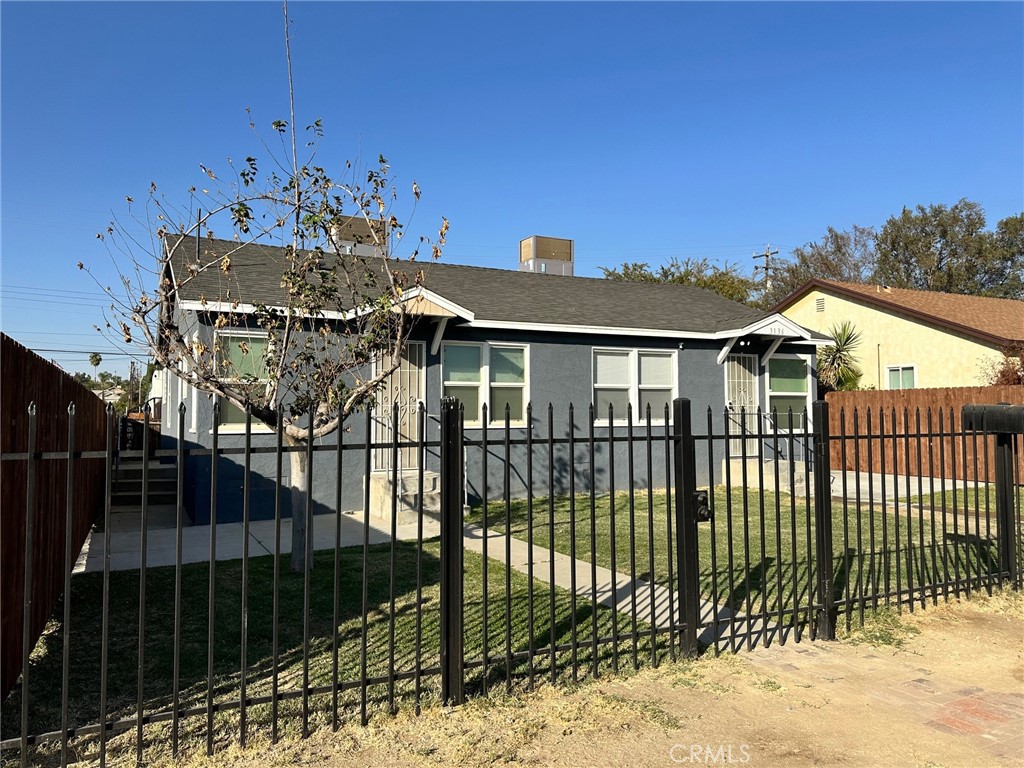 a view of a house with a iron gate