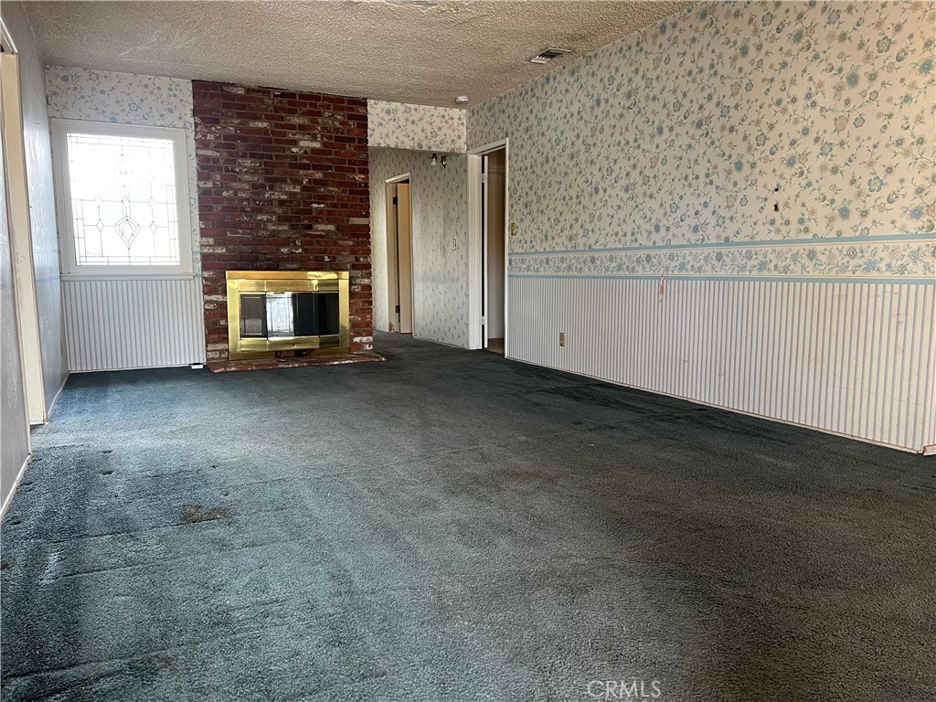 an empty room with a fireplace