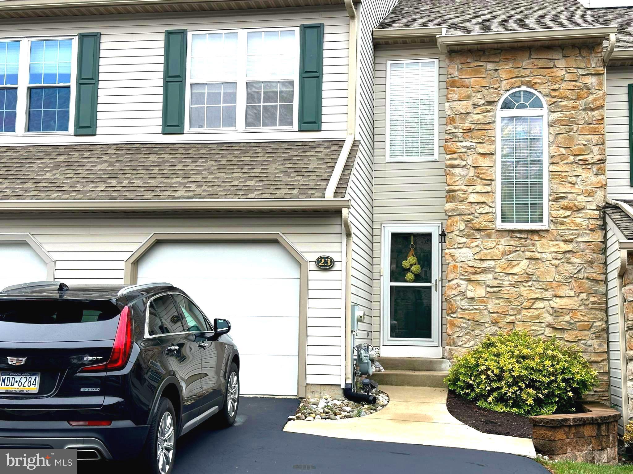 a view of front door of house with car parked