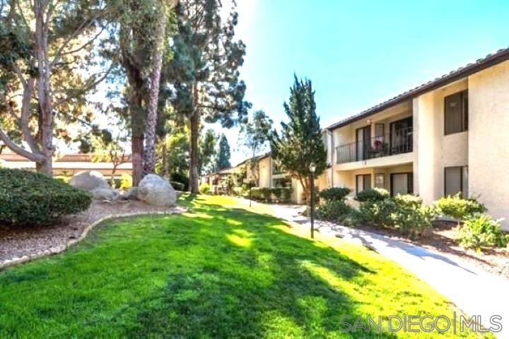 a view of backyard of house with green space