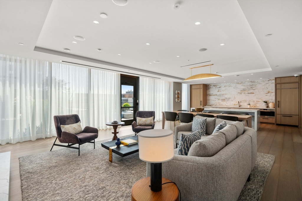 a living room with furniture and floor to ceiling windows