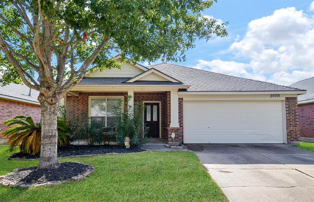 What a perfect place to call your new RENTAL home! It's located at 25015 Mills Pass Court, Katy, TX, in the Mills Pointe community. Shown here are the dual attached garages atop the roomy driveway, with easy access to the front entrance.